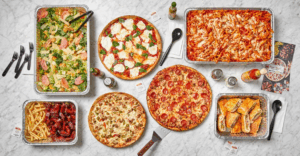 (A mouthwatering spread of catering favorites—classic pizzas, wings, pasta, salad, and more—perfect for feeding a crowd with flavor and ease.)