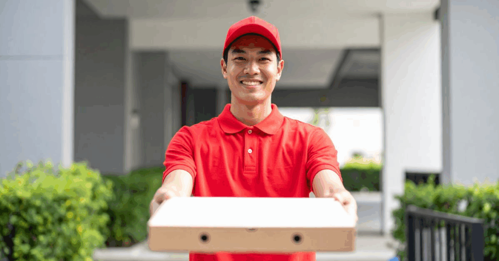 ALT: “Papa Ray’s delivery driver delivering oversized pizza box”