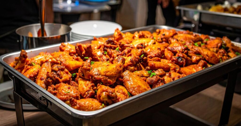 Catering tray filled with assorted flavored wings
