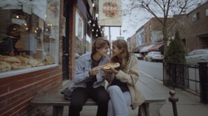 Places to Eat in Logan Square Chicago: Why Locals Choose Papa Ray’s 1 Couple sharing pizza in Chicago, enjoying a casual meal.