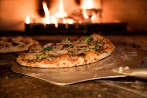 Cheap Comfort Food Near Me: Filling Meals That Won’t Break the Bank 2 Fresh pizza baking in a wood-fired oven.