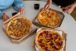 Group Ordering Restaurants: The Best Takeout Food for Large Groups 1 Catering trays of pizza and sides set out for a group.