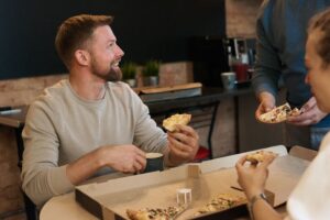 Chicago Deep Dish Pizza in Indianapolis: Bringing Big Flavor to Every Bite 2 Group sharing a deep-dish pizza at a table.