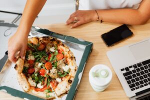 Pizza and Wings Near Me Open Now: The Best Choice for Meetings and Group Orders 2 Delivery driver handing off pizza boxes at an office.