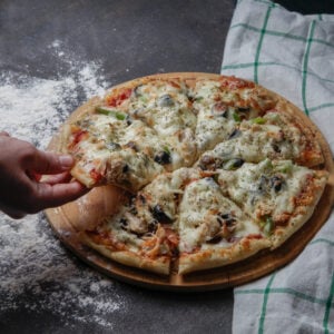 Pizza Places in Naperville IL: Finding Great Pizza for Every Occasion 1 Fresh pizza with melted cheese on a wooden table.