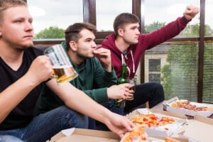 Win Tickets to Bears vs. Patriots: Papa Ray's October Giveaway 1 Three men watching sports together while eating pizza and drinking beer.